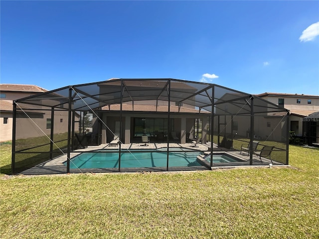 view of swimming pool featuring a lawn, a lanai, and a patio area