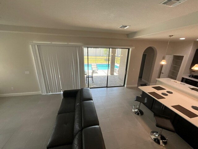 interior space with tile patterned flooring and a textured ceiling