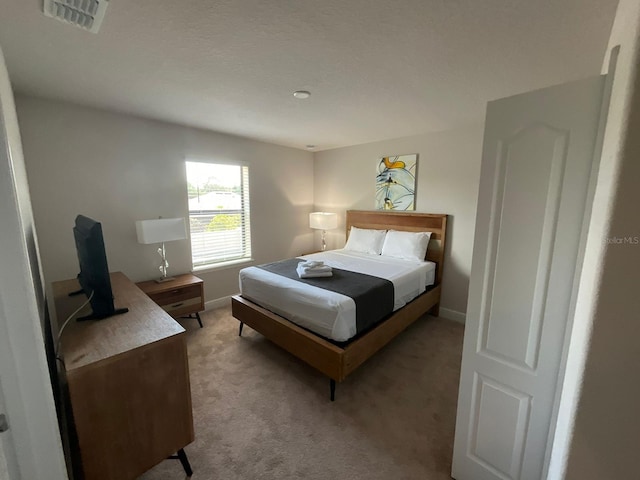 bedroom featuring light colored carpet