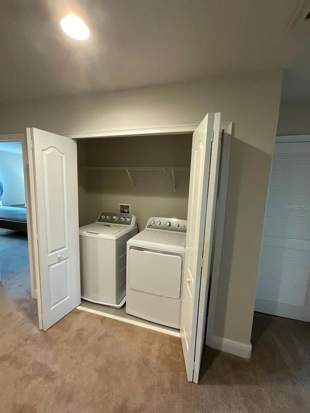 washroom with light carpet and washer and clothes dryer