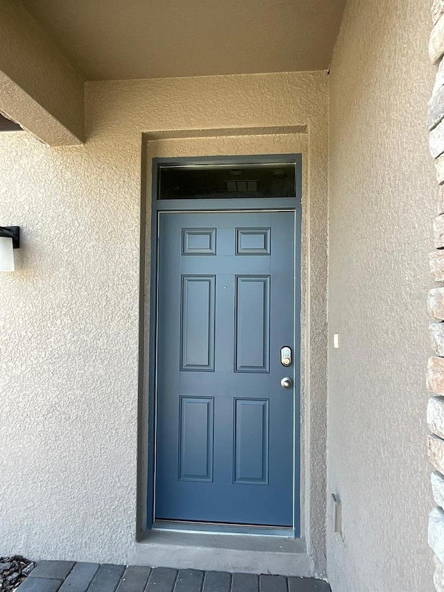 226 Macaulays Cv, Haines City, FL 33844 - property entrance with stucco siding