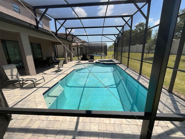 226 Macaulays Cv, Haines City, FL 33844 - view of swimming pool featuring glass enclosure, a patio area, and a pool with connected hot tub