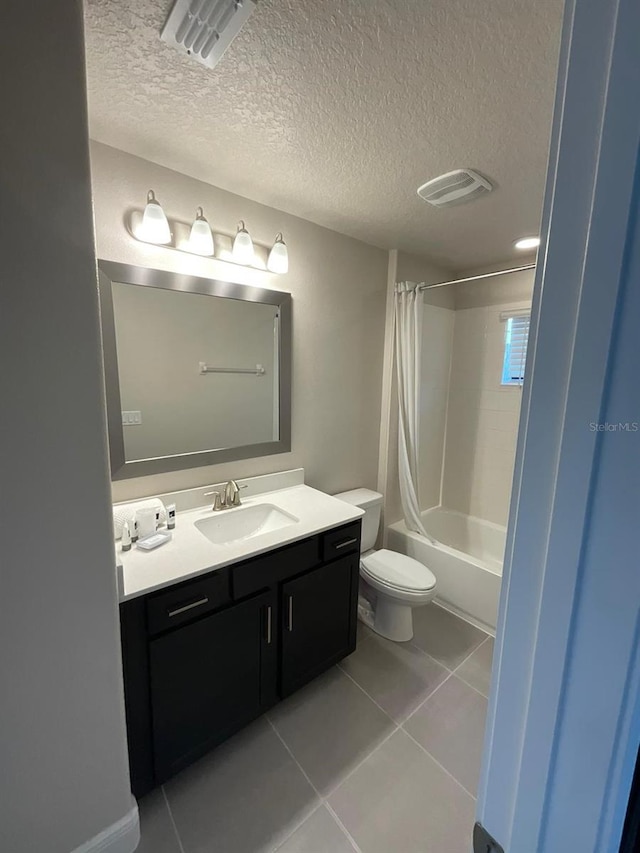 226 Macaulays Cv, Haines City, FL 33844 - full bathroom featuring vanity, shower / bath combo with shower curtain, tile patterned flooring, and a textured ceiling