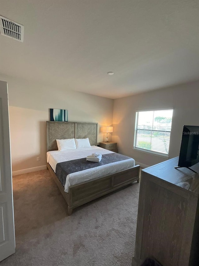 bedroom with dark colored carpet