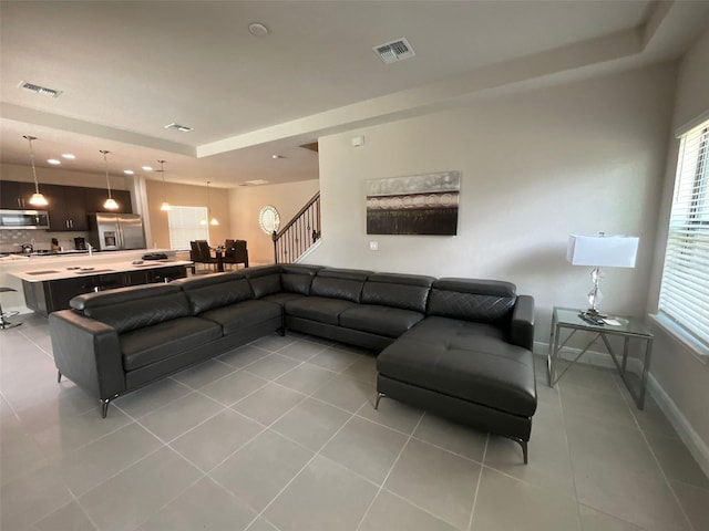 226 Macaulays Cv, Haines City, FL 33844 - living room with a raised ceiling, light tile patterned floors, plenty of natural light, recessed lighting, and stairway
