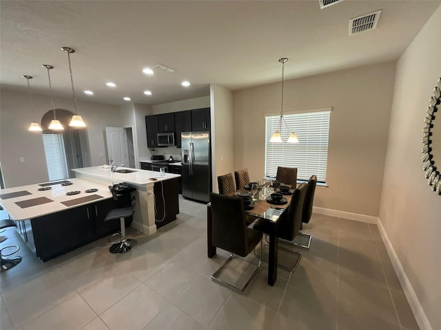 tiled dining area featuring sink