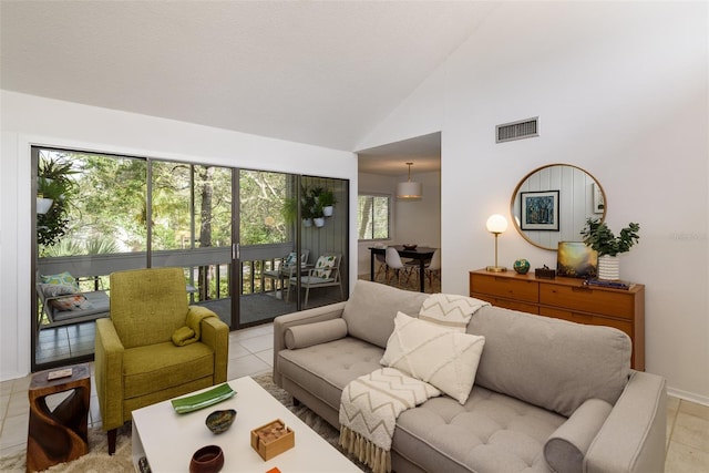 living room featuring light tile patterned flooring, plenty of natural light, and high vaulted ceiling