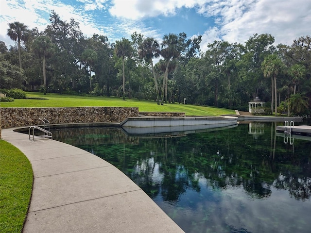 view of dock featuring a yard and a water view