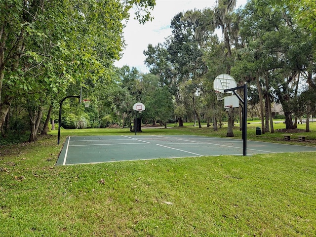 view of basketball court with a yard