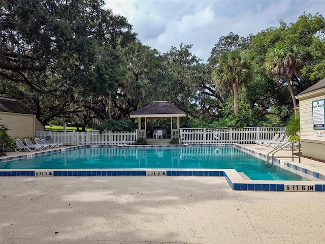 view of swimming pool with a patio area and a gazebo