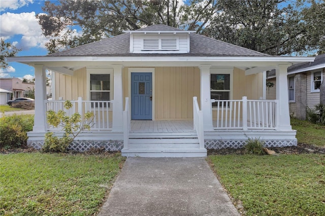 bungalow-style house with a front lawn and a porch