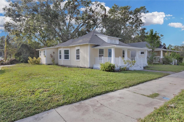 295 S Oak Ave, Bartow, FL 33830 - view of front of house with a porch, a front yard, and board and batten siding