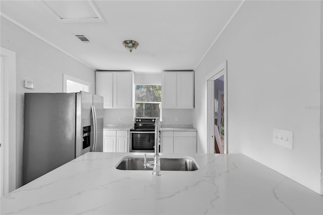 kitchen with sink, light stone countertops, stainless steel appliances, and white cabinetry