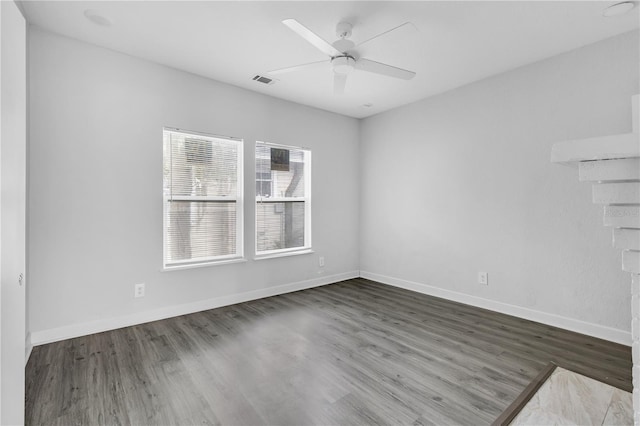 unfurnished room with ceiling fan and dark hardwood / wood-style flooring