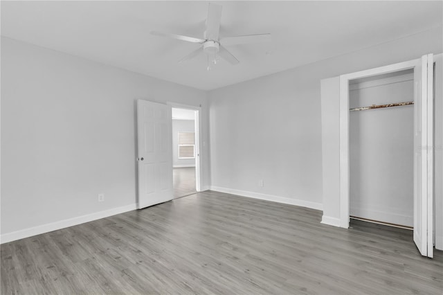 unfurnished bedroom featuring a closet, light wood-type flooring, and ceiling fan