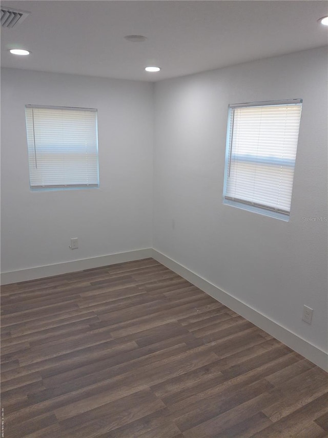 spare room featuring dark wood-type flooring