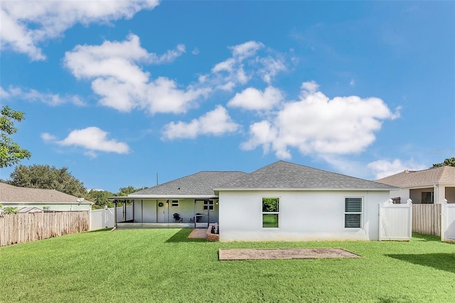 rear view of property with a patio area and a yard