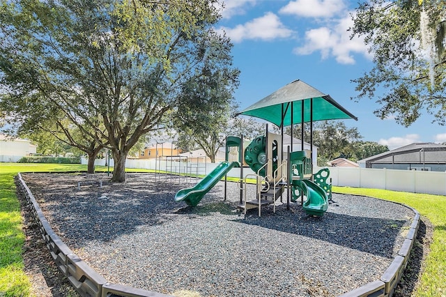 view of playground with a lawn