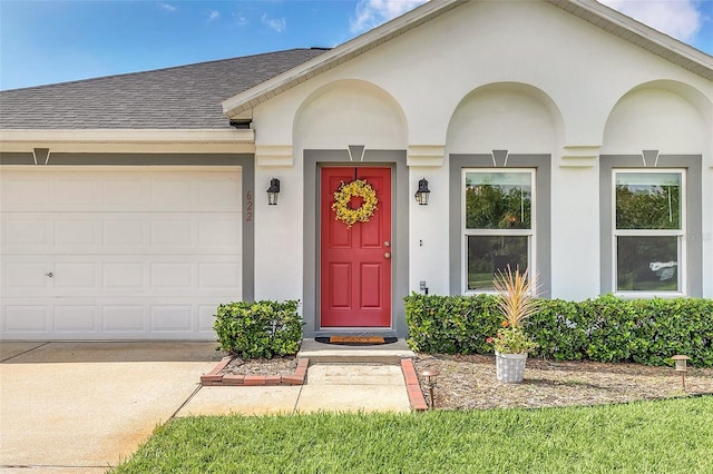 view of exterior entry with a garage