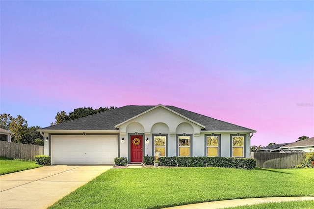 ranch-style house with a lawn and a garage