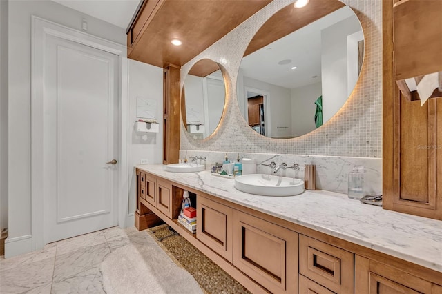 bathroom featuring vanity and decorative backsplash