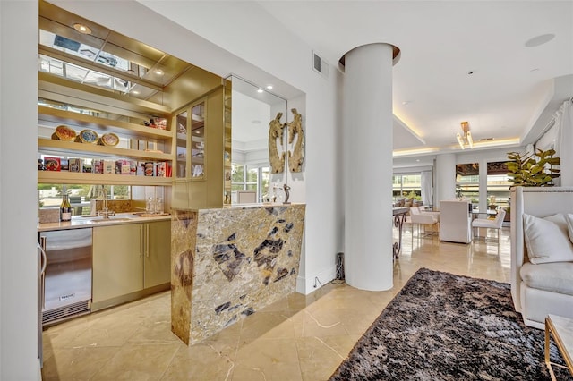 bar featuring a wealth of natural light, sink, dishwasher, and stone counters