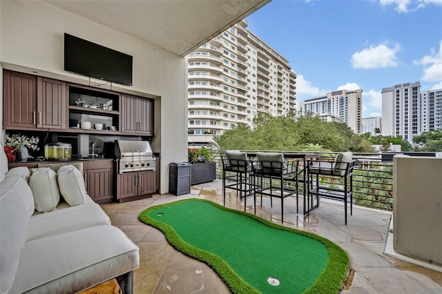 exterior space featuring an outdoor bar, a grill, and a balcony