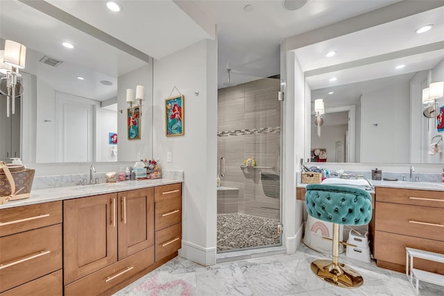 bathroom featuring vanity and a shower with shower door