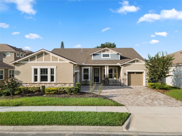 view of front of property with a porch and a garage