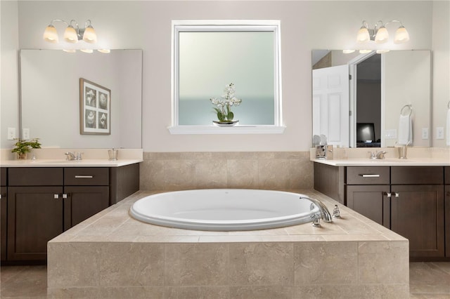 bathroom featuring vanity, tiled bath, and tile patterned floors