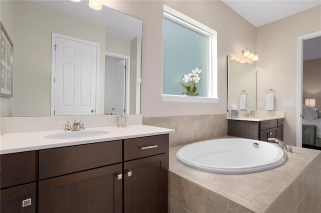 bathroom with vanity and a relaxing tiled tub