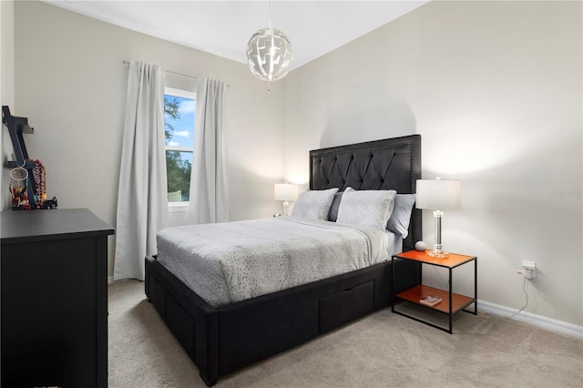 bedroom with an inviting chandelier and light colored carpet