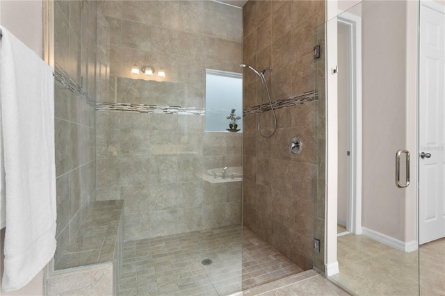 bathroom with tile patterned floors and a shower with shower door