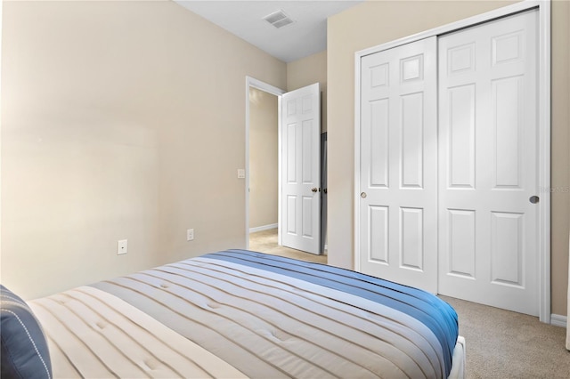 bedroom featuring a closet and light colored carpet