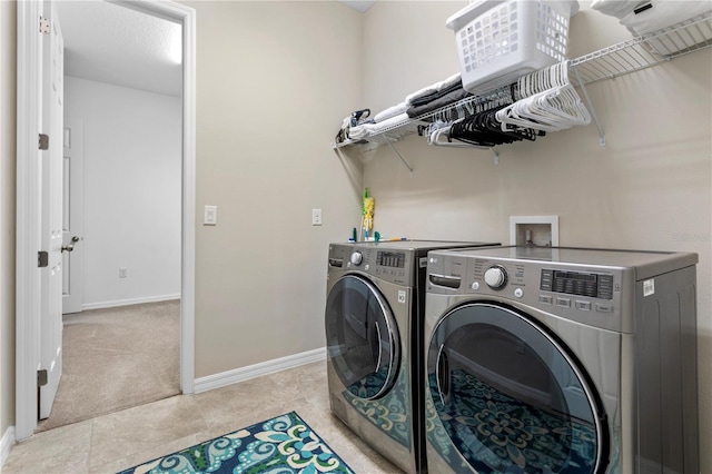 laundry area with light colored carpet and separate washer and dryer