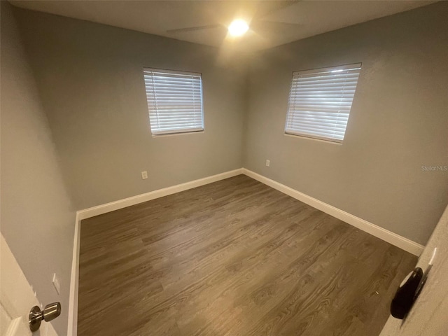 empty room with dark hardwood / wood-style floors