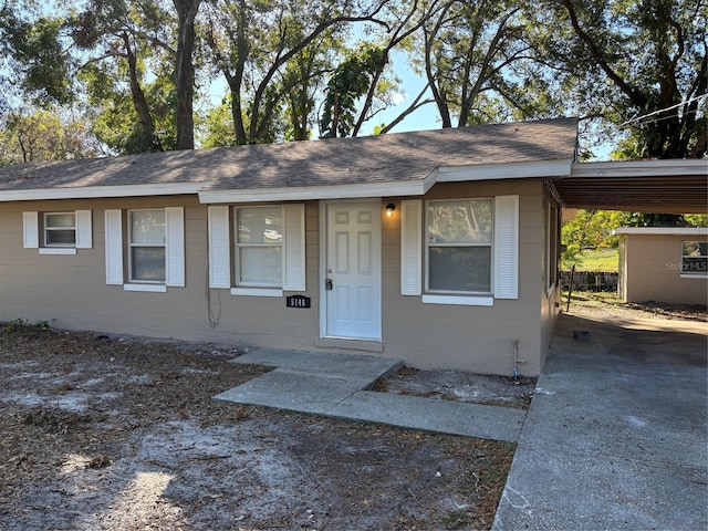 ranch-style house featuring a carport