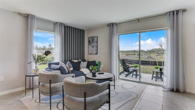 living room featuring a healthy amount of sunlight and light tile patterned flooring