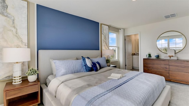 bedroom featuring carpet floors and connected bathroom