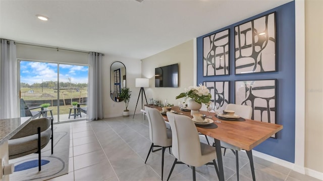 dining space featuring light tile patterned floors