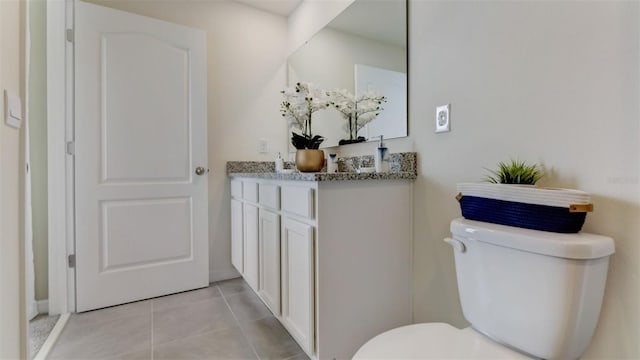 bathroom featuring vanity, toilet, and tile patterned floors