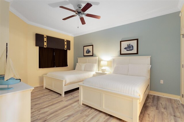 bedroom featuring crown molding, ceiling fan, and light hardwood / wood-style flooring