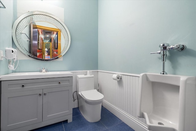 1021 Fantasy Dr, Davenport, FL 33896 - bathroom with a wainscoted wall, vanity, a shower, and tile patterned floors