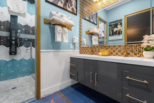 1021 Fantasy Dr, Davenport, FL 33896 - bathroom with double vanity, wainscoting, a tile shower, and tile patterned floors