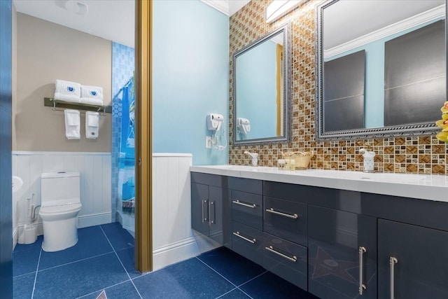 1021 Fantasy Dr, Davenport, FL 33896 - bathroom featuring tile patterned floors, a wainscoted wall, and double vanity