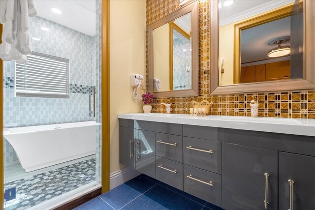 1021 Fantasy Dr, Davenport, FL 33896 - full bathroom with a freestanding tub, double vanity, tile patterned floors, and backsplash