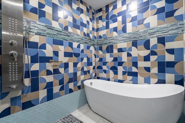 1021 Fantasy Dr, Davenport, FL 33896 - bathroom with tile walls, a freestanding bath, marble finish flooring, and tiled shower