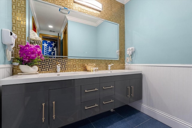 1021 Fantasy Dr, Davenport, FL 33896 - full bath featuring ornamental molding, double vanity, a wainscoted wall, and tile patterned floors