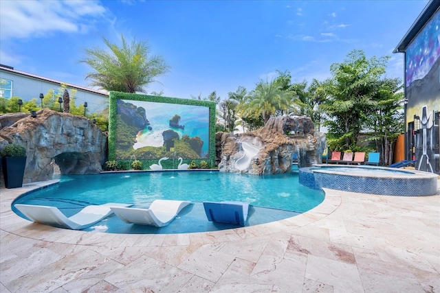 1021 Fantasy Dr, Davenport, FL 33896 - view of swimming pool with a water slide, a pool with connected hot tub, and a patio area