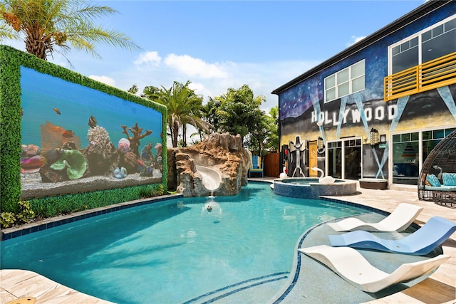 1021 Fantasy Dr, Davenport, FL 33896 - view of swimming pool with a water slide and a pool with connected hot tub